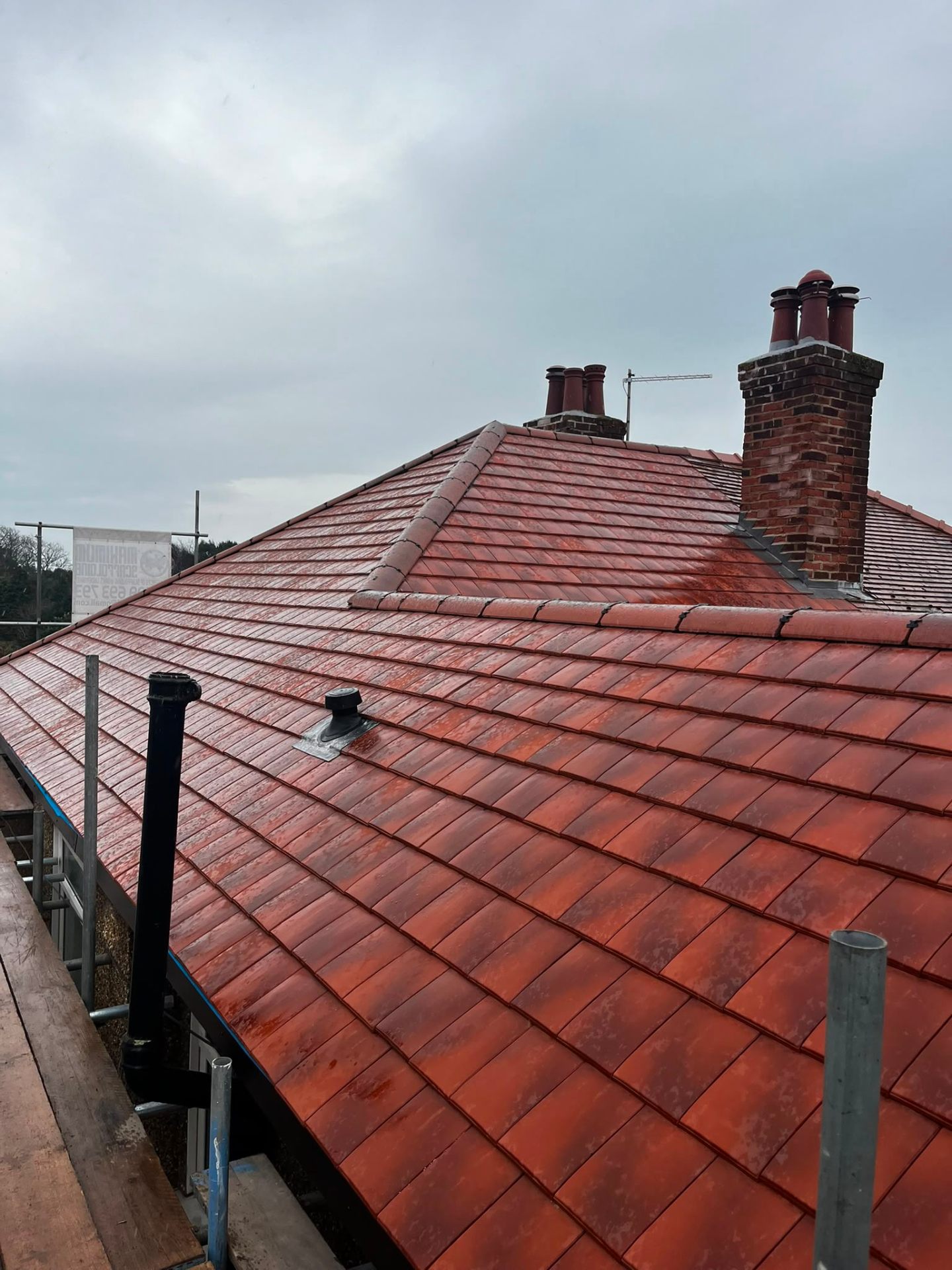 Newly completed grey concrete interlocking tile roof on a full pitched re-tile in Wirral by RTC Roofing