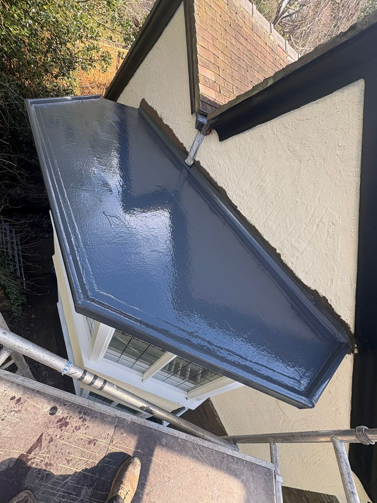 Newly installed seamless GRP fibreglass flat roof by RTC Roofing over a rear bay extension, Wirral